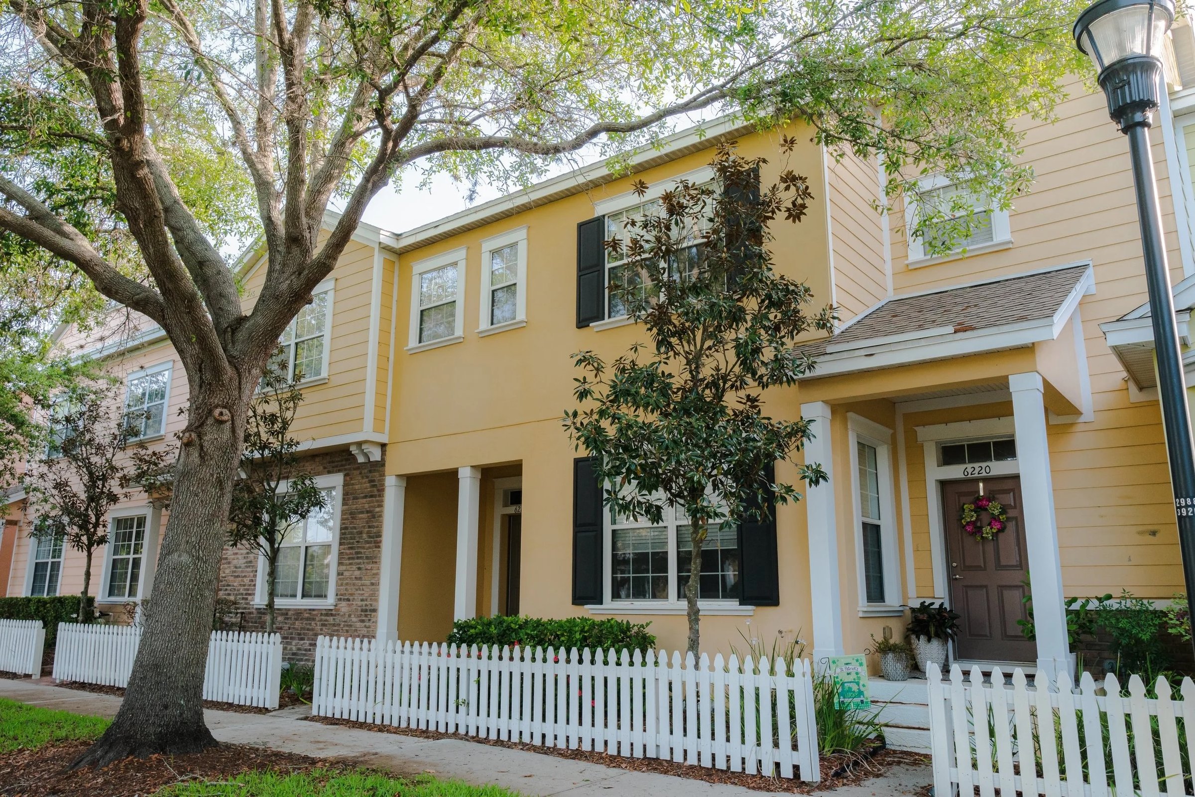 Yellow townhome with picket fence in Winthrop Village